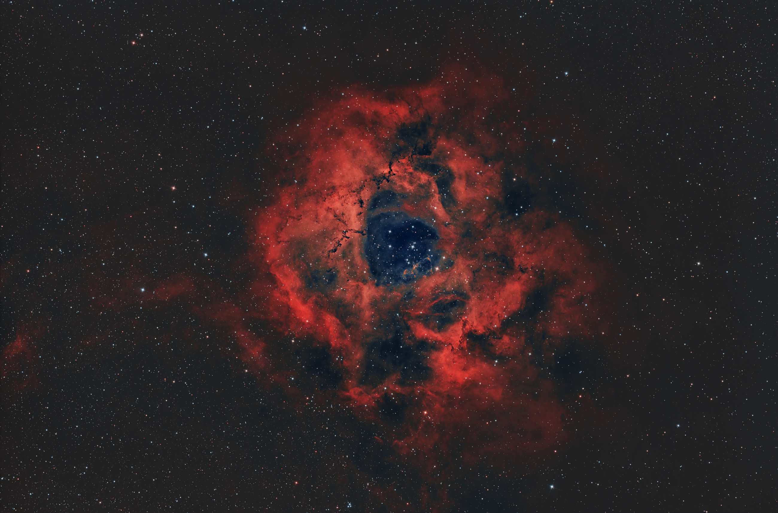 Der Rosettennebel (Caldwell 49) ist eine H-II-Region, die sich am Rand einer riesigen Molekülwolke in der Einhorn-Region der Milchstraße befindet. Die Sterne des offenen Sternhaufens NGC 2244 im Zentrum sind aus der Materie des Nebels entstanden.
